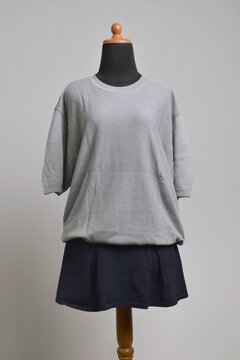 Oversize gray t-shirt with navy mini skirt on a mannequin display