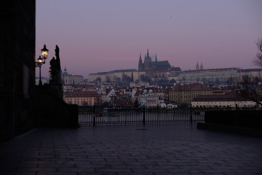 Empty Charles Bridge looking toward Prague Castle at twilight