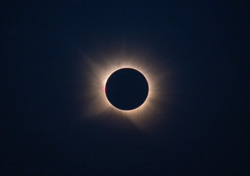 Total solar eclipse with brilliant corona visible in dark sky