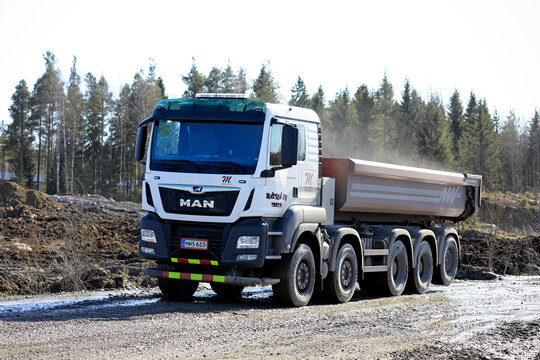 White MAN TGS 45.500 tipper truck at work on a construction site on a sunny day of spring.