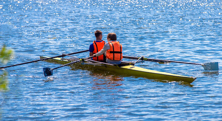 The guys are sailing on a rowing boat  © licvin