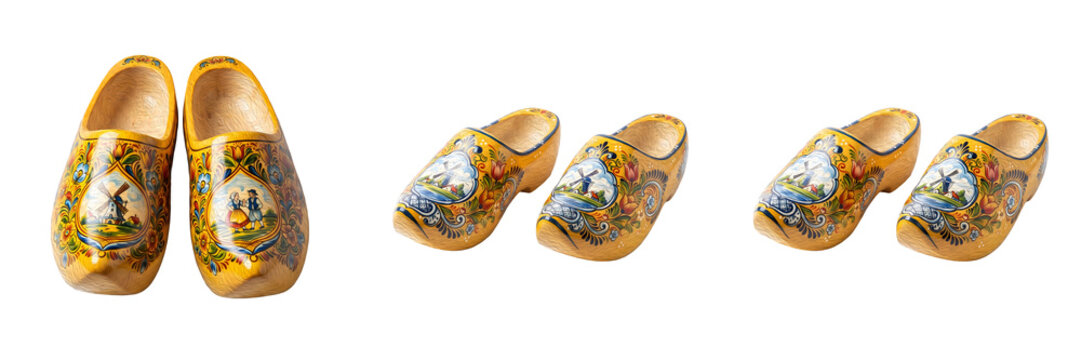Traditional Dutch wooden clogs painted with windmill landscapes yellow handmade wooden shoes typical Netherlands souvenir folk footwear isolated on white background stock photo