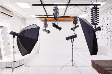 Professional Photo Studio Interior with Lighting Equipment and White Backdrop © sandsun