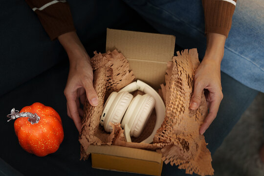 Close up of hands unboxing headphones package order for online shopping delivery
