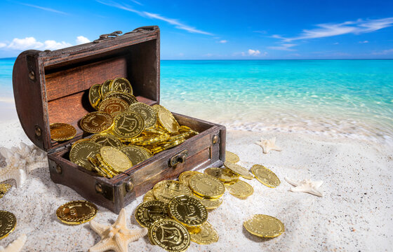 Treasure chest on a white sand beach with gold coins.