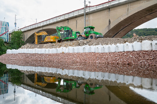 Construction site, excavators and road roller, temporary bank reinforcement, sandbags and crushed stone, bridge Wasserbillig, Luxembourg
