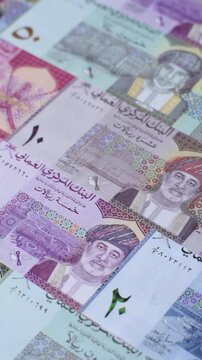 Oman, omani paper money, rial or riyal banknotes and baisa coins as currency for exchange or travel. Omani money as a business background