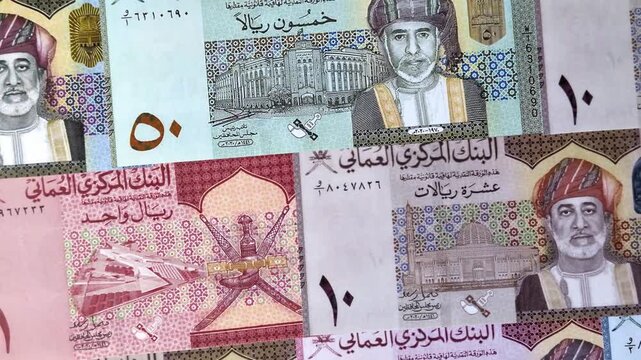 Oman, omani paper money, rial or riyal banknotes and baisa coins as currency for exchange or travel. Omani money as a business background
