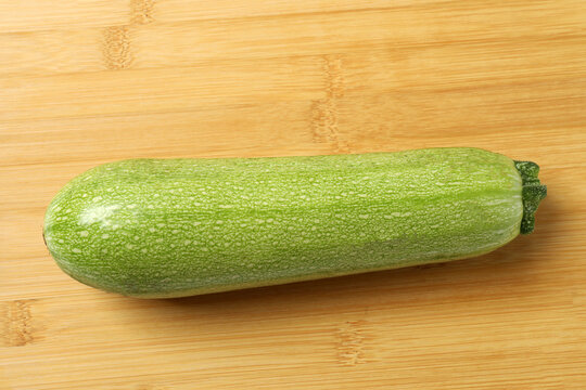 Zucchini on a colored background. Organic vegetarian vegetables. Healthy food. Negative space. Space for text. Healthy eating concept.
