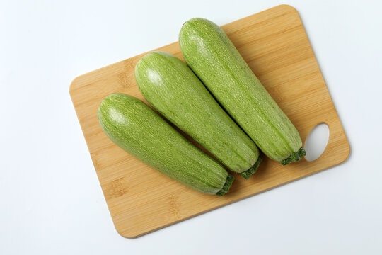 Zucchini on a colored background. Organic vegetarian vegetables. Healthy food. Negative space. Space for text. Healthy eating concept.
