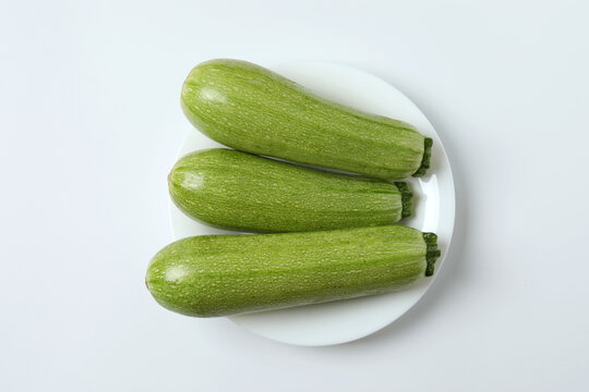 Zucchini on a colored background. Organic vegetarian vegetables. Healthy food. Negative space. Space for text. Healthy eating concept.
