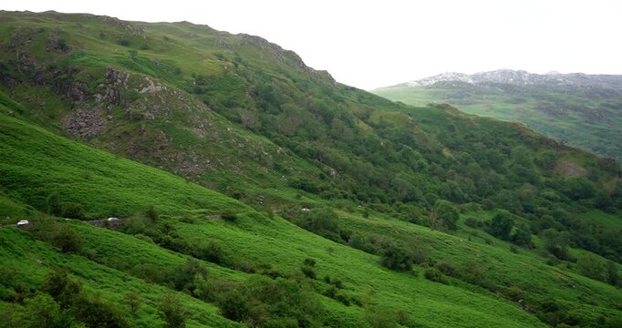 Cars driving along mountain road in Snowdonia National Park, Wales