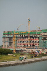 Portrait View of Construction Site of a Building Near Shoreline of The Sea. © DegreeStudioMY