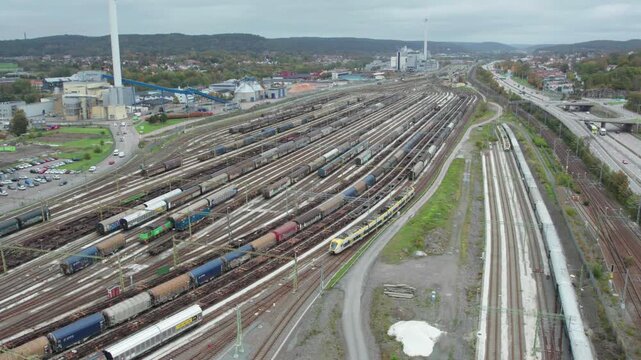 Aerial View of commuter train passing by train depot Savenas, Gothenburg, Sweden