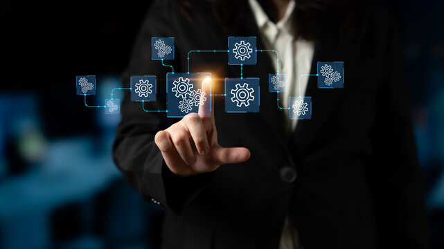 Business Professional Interacting with Digital Gears Symbolizing Automation and Process Improvement in Modern Work Environment. Entropy.
