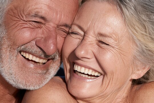 Senior couple sharing moment with eyes closed and smiles