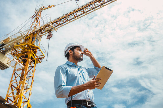 Indian Asian Engineer Worker Holding Tablet Inspection Construction Site Tower Crane