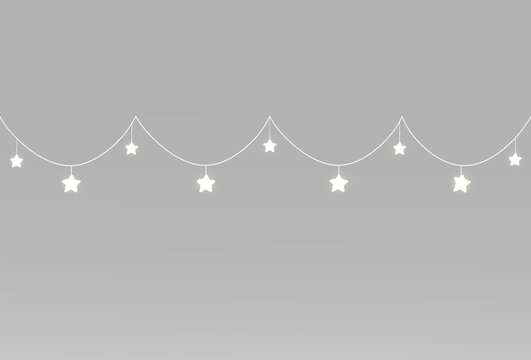Festive star garlands with delicate white light suspended on two gently curved hanging strings above