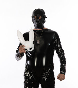 Fetish man in black latex isolated on white background