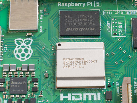 Extreme macro of Raspberry Pi 5 Broadcom CPU chip on green circuit board