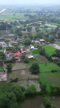 Aerial View of Indian Rural Village Surrounded by Green Agricultural Fields