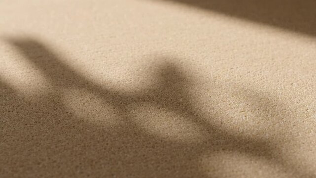 Abstract textured neutral surface, soft shadow light play detail, minimal background, serene light and shadow textured surface, calm tranquil atmosphere, peaceful contemplation, inviting glow