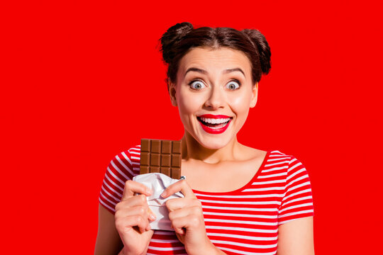 Close-up portrait of nice cute charming attractive glamorous crazy cheerful cheery girl in striped t-shirt holding in hands desirable dessert life lifestyle advert isolated on pink pastel background