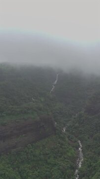 Vertical Aerial View of Lonavala Waterfall and Misty Green Hills During Monsoon Maharashtra
