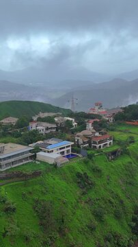 Vertical Aerial View of Lonavala Waterfall and Misty Green Hills During Monsoon Maharashtra