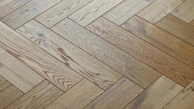 Oak herringbone parquet with natural wooden floor texture, classic hardwood surface pattern for rustic backdrop, geometric plank design, elegant residential flooring renovation material.