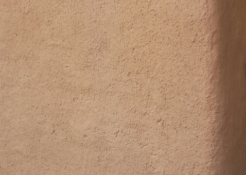 Wall of clay house structure, home building from mud. Selective focus