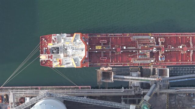 Large tanker moored at industrial terminal in Port of Veracruz, Mexico, aerial overhead zenithal backdrop texture