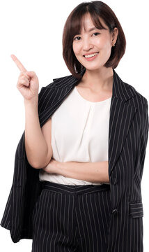 Cheerful asian woman smiling and pointing finger upward showing happy confident gesture in professional corporate business suit