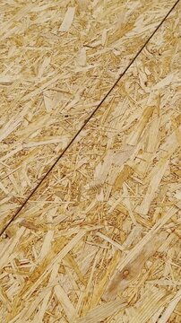 Oriented MDF strand board surface with compressed wood flakes makes up platform prep area, vertical textured wood backdrop