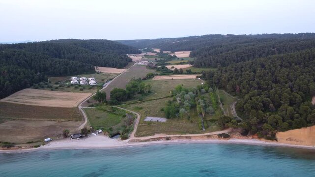 Aerial Flyover of Rural Farmland, Pine Forest, Beach and Mediterranean Sea in Kassandra Greece