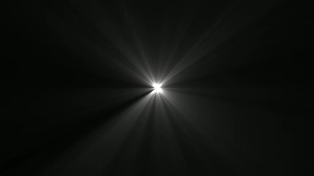 Bright white starburst light effect with rays radiating from the center on a solid black background