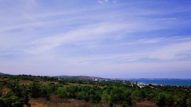 This shows the beautiful coastline of Mui Ne Lam Dong. Clear skies and blue waters make the view enjoyable. The area is filled with greenery and offers a nice perspective on the landscape.