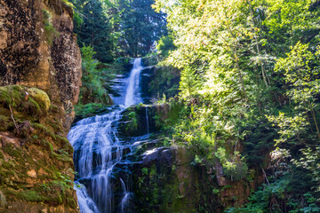 Kamieńczyka Waterfall cascades through a forest near Szklarska Poręba in the Karkonosze Mountains of Poland. Concept of nature travel, outdoor wellbeing, wilderness escape and scenic discovery. © Ina