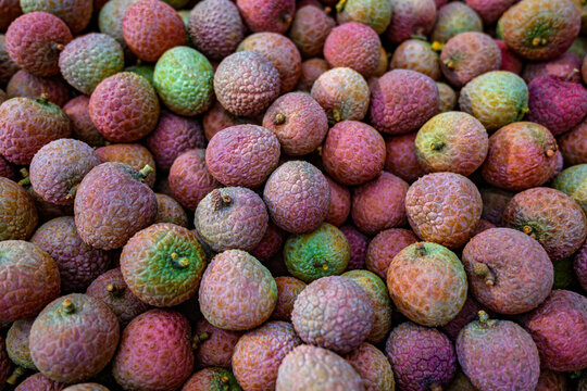 Lychee fruits with colorful rough skin texture.