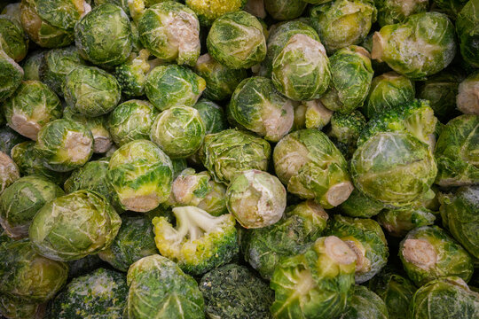 Closeup of frozen Brussels sprout cabbage, healthy green vegetable food texture.