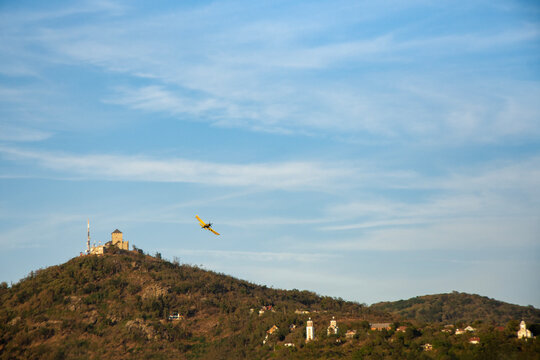 Small airplane flying over the Vr&scaron;ac hill