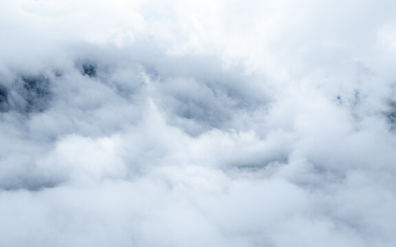 Aerial view of dense white clouds covering the mountainous landscape in Valldal, More og Romsdal, Norway.