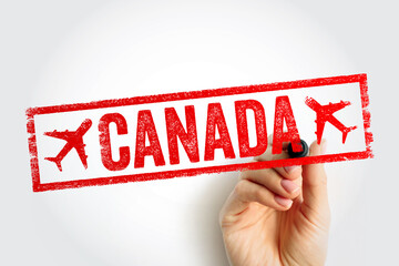 CANADA stamp held by a hand in closeup, showing bold travel destination label in a rough frame, ideal for tourism, aviation themes, journey planning, global trips, promotion visuals for media use © dizain