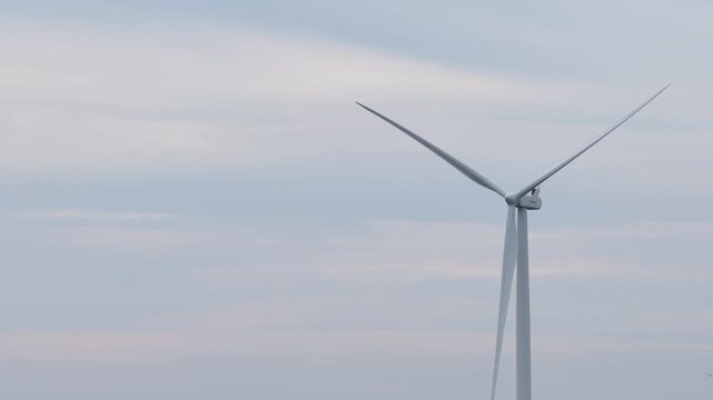 An aerial view of wind turbines for electricity generation captured by a drone camera.