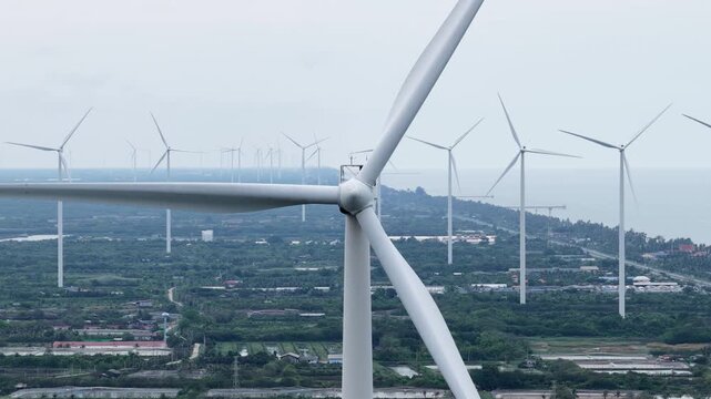 An aerial view of wind turbines for electricity generation captured by a drone camera.