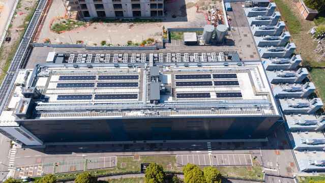 Aerial view of the Equinix Data Center featuring rooftop solar panels, cooling infrastructure, and surrounding parking areas in Castelletto, Lombardia, Italy.