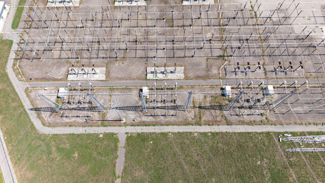 Aerial view of the Terna Baggio electrical substation featuring high-voltage power lines, metal structures, and electrical equipment in Settimo Milanese, Lombardia, Italy.