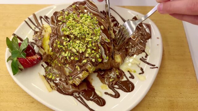 Hand Cutting Chocolate Bagel with Pistachio Crumb Topping &ndash; Cafe Dessert