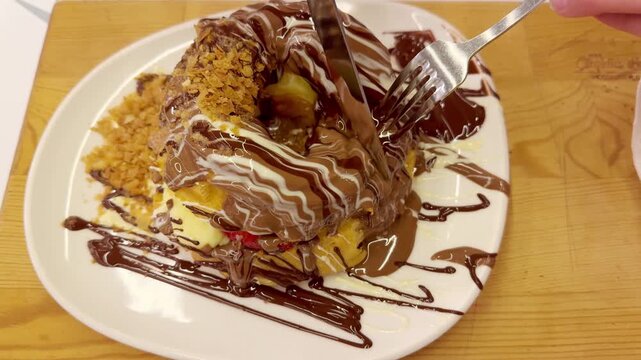 Hand Cutting Chocolate Bagel with Pistachio Crumb Topping &ndash; Cafe Dessert