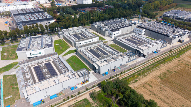 Aerial view of the DATA4 Milan Campus featuring large data center buildings with rooftop cooling units and solar panels, Zona Industriale, Lombardia, Italy.